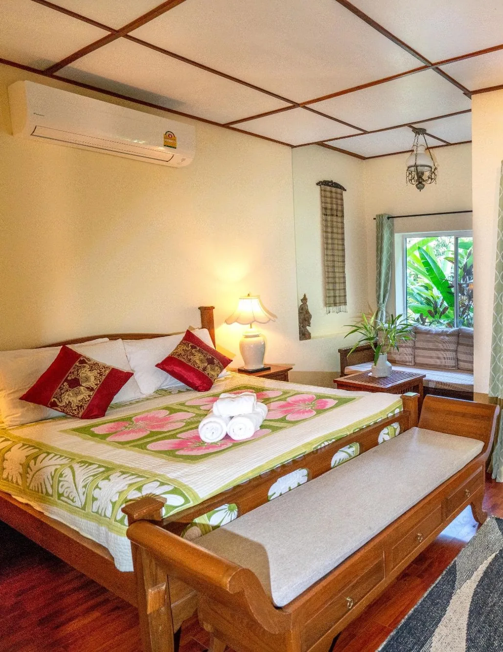 Nest room with floral bedspread and open balcony doors