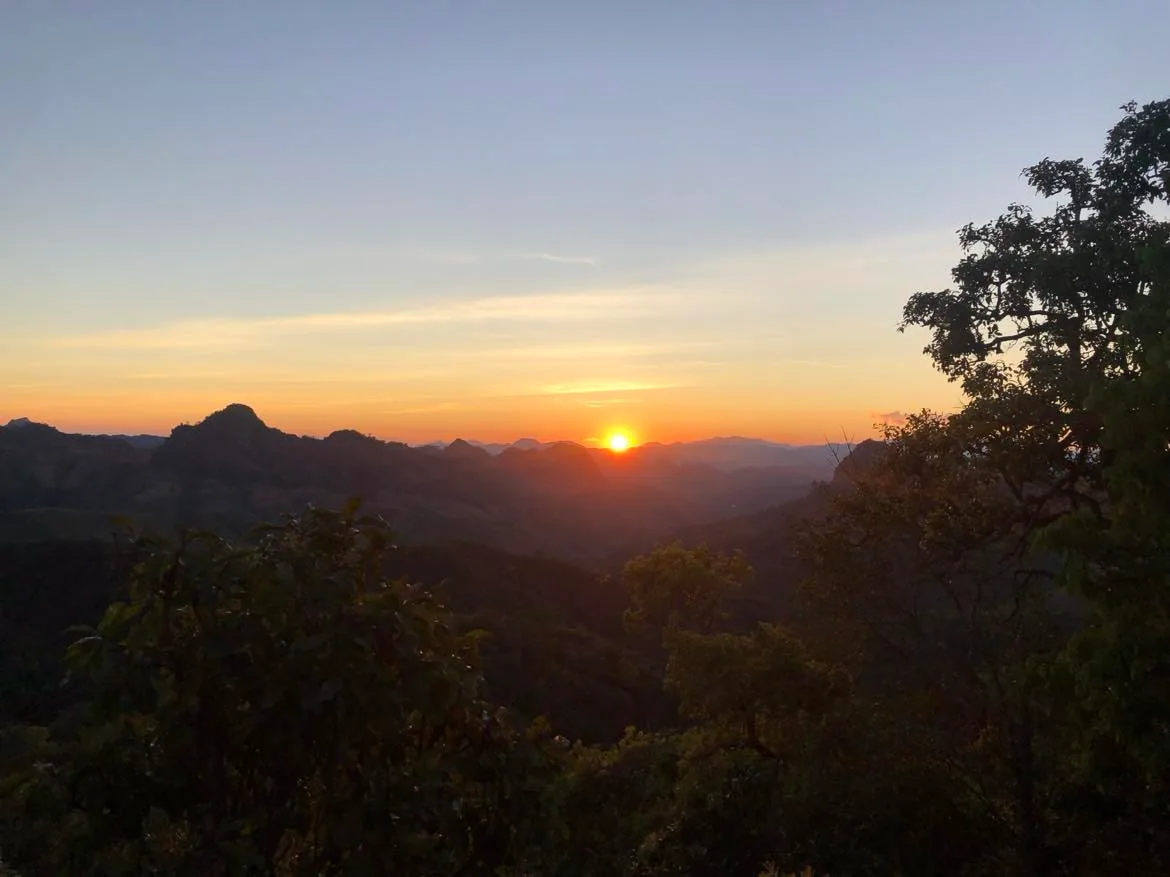Sun setting over forested ridges near the Myanmar border